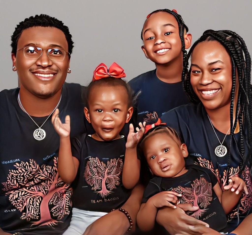 Smiling family wearing matching New Wave Spiritual Apparel shirts.